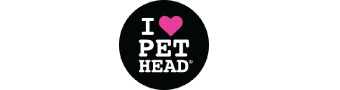 A wet dog in the shower next to some Pet Head products