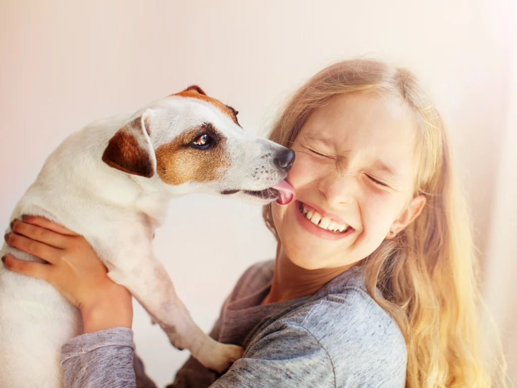Dog licking girl