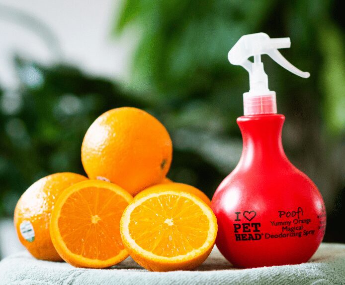 Pet Head Poof Spray next to some oranges
